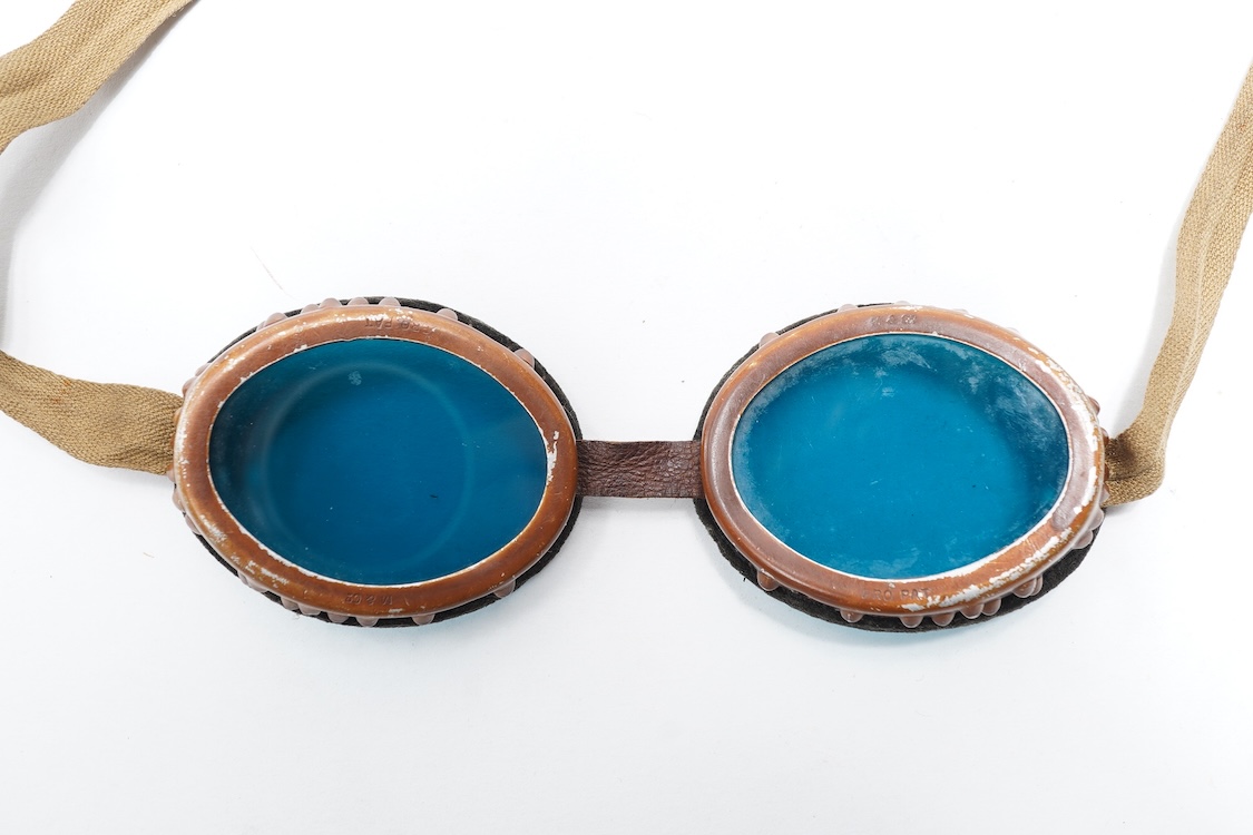 Two pairs of WW2 desert goggles, blue tinted lenses, one with original tin box
